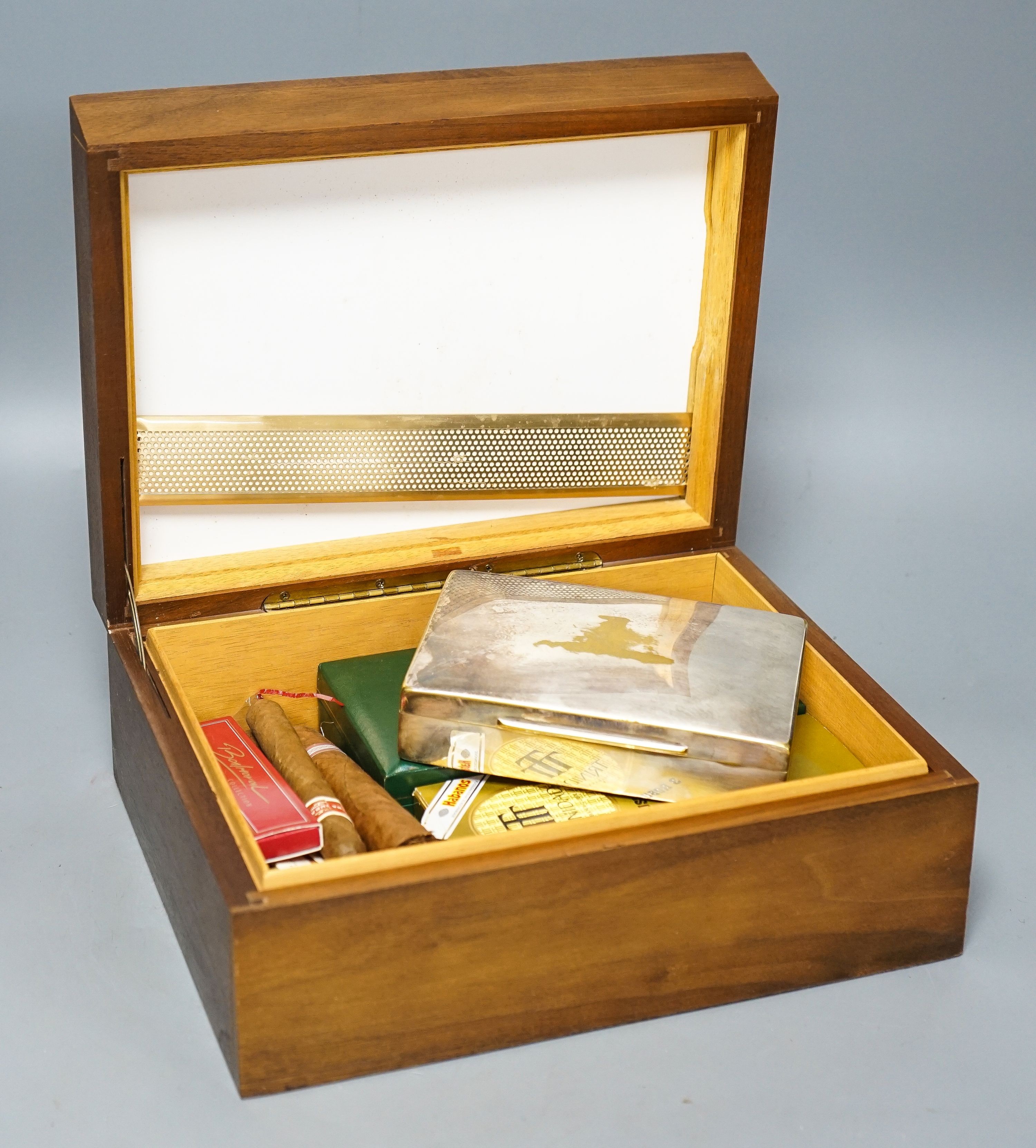 A cased Davidoff cigar cutter, walnut humidor, plated cigarette box, various cigars etc.